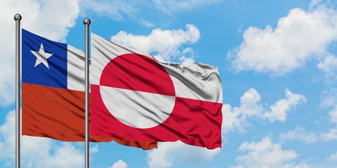 Chile and Greenland flag waving in the wind against white cloudy blue sky together. Diplomacy concept, international relations.