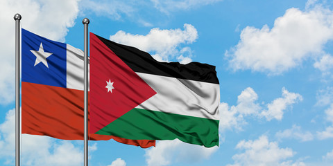 Chile and Jordan flag waving in the wind against white cloudy blue sky together. Diplomacy concept, international relations.