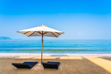 Chair umbrella and lounge on the beautiful beach sea ocean on sky