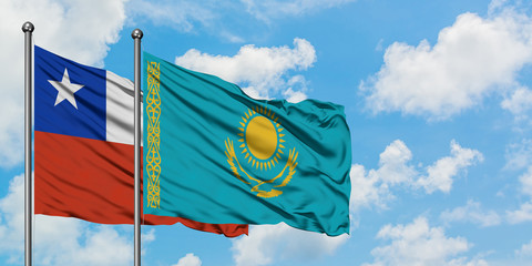 Chile and Kazakhstan flag waving in the wind against white cloudy blue sky together. Diplomacy concept, international relations.