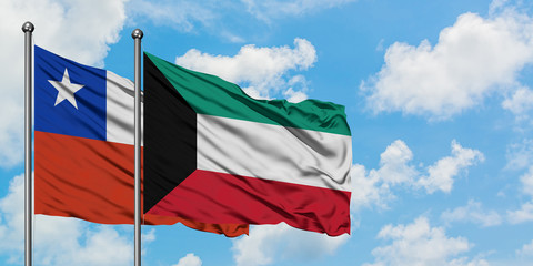 Chile and Kuwait flag waving in the wind against white cloudy blue sky together. Diplomacy concept, international relations.