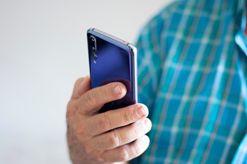 Man holding modern cellphone with his hands