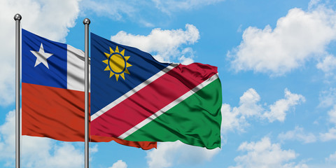 Chile and Namibia flag waving in the wind against white cloudy blue sky together. Diplomacy concept, international relations.