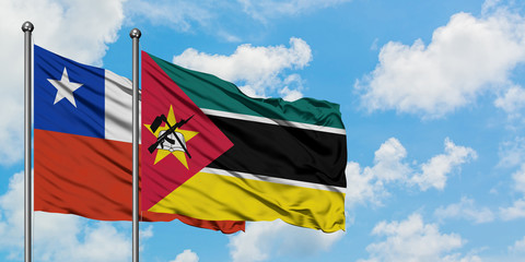 Chile and Mozambique flag waving in the wind against white cloudy blue sky together. Diplomacy concept, international relations.