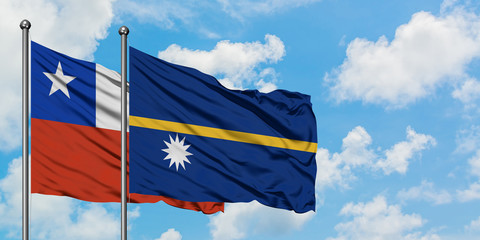 Chile and Nauru flag waving in the wind against white cloudy blue sky together. Diplomacy concept, international relations.
