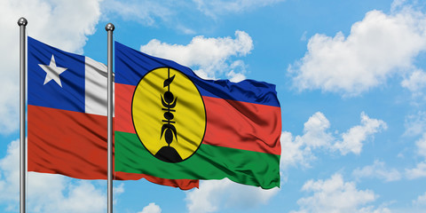 Chile and New Caledonia flag waving in the wind against white cloudy blue sky together. Diplomacy concept, international relations.