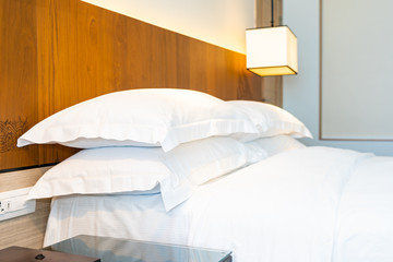 Fototapeta na wymiar White comfortable pillow on bed decoration