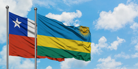 Chile and Rwanda flag waving in the wind against white cloudy blue sky together. Diplomacy concept, international relations.