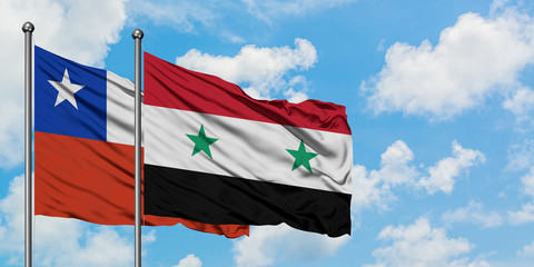 Chile and Syria flag waving in the wind against white cloudy blue sky together. Diplomacy concept, international relations.