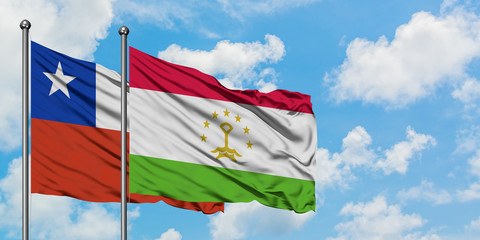 Chile and Tajikistan flag waving in the wind against white cloudy blue sky together. Diplomacy concept, international relations.