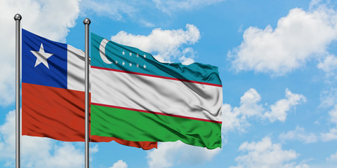Chile and Uzbekistan flag waving in the wind against white cloudy blue sky together. Diplomacy concept, international relations.