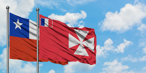 Chile and Wallis And Futuna flag waving in the wind against white cloudy blue sky together. Diplomacy concept, international relations.