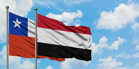 Chile and Yemen flag waving in the wind against white cloudy blue sky together. Diplomacy concept, international relations.