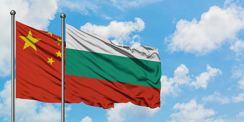 China and Bulgaria flag waving in the wind against white cloudy blue sky together. Diplomacy concept, international relations.
