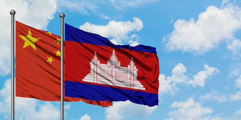China and Cambodia flag waving in the wind against white cloudy blue sky together. Diplomacy...