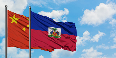 China and Haiti flag waving in the wind against white cloudy blue sky together. Diplomacy concept,...
