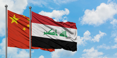 China and Iraq flag waving in the wind against white cloudy blue sky together. Diplomacy concept, international relations.