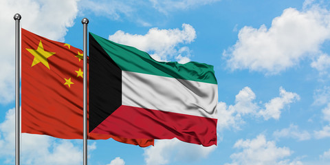 China and Kuwait flag waving in the wind against white cloudy blue sky together. Diplomacy concept, international relations.