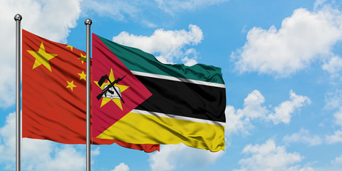 China and Mozambique flag waving in the wind against white cloudy blue sky together. Diplomacy concept, international relations.