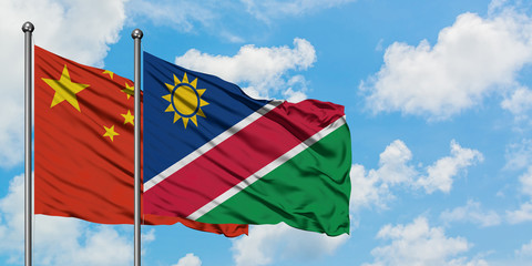 China and Namibia flag waving in the wind against white cloudy blue sky together. Diplomacy concept, international relations.