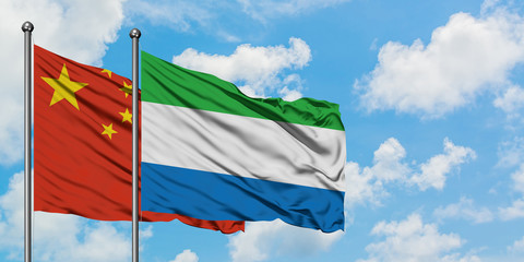 China and Sierra Leone flag waving in the wind against white cloudy blue sky together. Diplomacy concept, international relations.