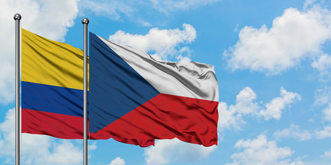 Colombia and Czech Republic flag waving in the wind against white cloudy blue sky together. Diplomacy concept, international relations.