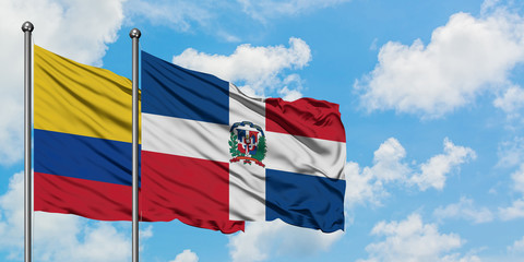 Colombia and Dominican Republic flag waving in the wind against white cloudy blue sky together. Diplomacy concept, international relations.