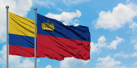 Colombia and Liechtenstein flag waving in the wind against white cloudy blue sky together. Diplomacy concept, international relations.