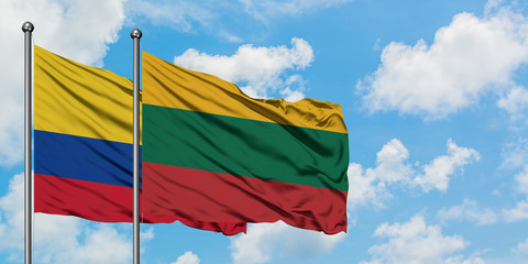 Colombia and Lithuania flag waving in the wind against white cloudy blue sky together. Diplomacy concept, international relations.
