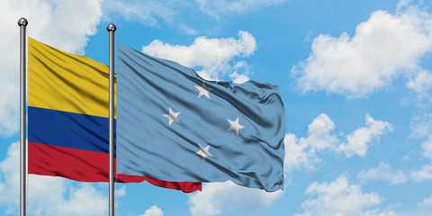 Colombia and Micronesia flag waving in the wind against white cloudy blue sky together. Diplomacy concept, international relations.