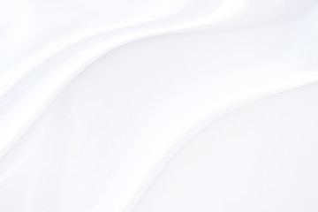 Background satin fabric white gray textures luxurious shiny that is abstract silver silk cloth  with patterns soft wave blur silky beautiful.