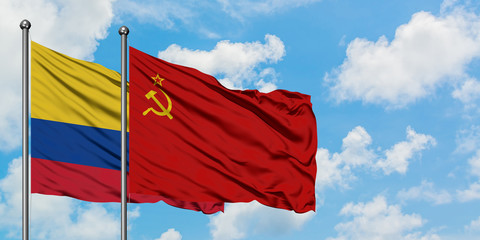 Colombia and Soviet Union flag waving in the wind against white cloudy blue sky together. Diplomacy concept, international relations.
