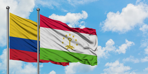 Colombia and Tajikistan flag waving in the wind against white cloudy blue sky together. Diplomacy concept, international relations.