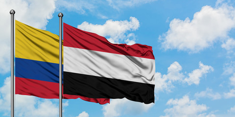 Colombia and Yemen flag waving in the wind against white cloudy blue sky together. Diplomacy concept, international relations.