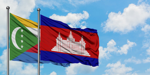 Comoros and Cambodia flag waving in the wind against white cloudy blue sky together. Diplomacy concept, international relations.