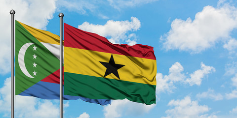 Comoros and Ghana flag waving in the wind against white cloudy blue sky together. Diplomacy concept, international relations.