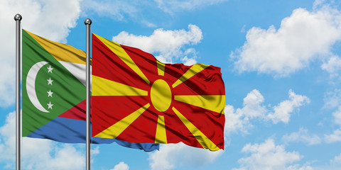 Comoros and Macedonia flag waving in the wind against white cloudy blue sky together. Diplomacy concept, international relations.
