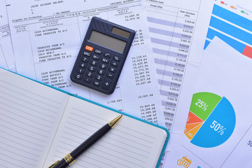 Pen, calculator and account reports. Business and finance concepts