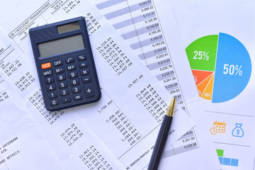 Pen, calculator and account reports. Business and finance concepts
