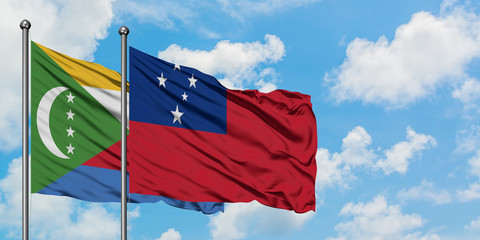 Comoros and Samoa flag waving in the wind against white cloudy blue sky together. Diplomacy concept, international relations.