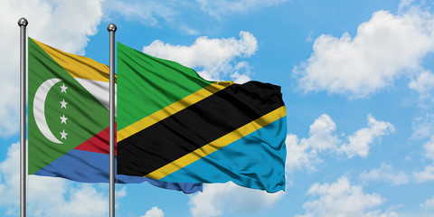 Comoros and Tanzania flag waving in the wind against white cloudy blue sky together. Diplomacy concept, international relations.