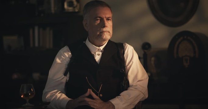 1930s gangster sitting in his office thinking about something