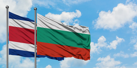 Costa Rica and Bulgaria flag waving in the wind against white cloudy blue sky together. Diplomacy concept, international relations.