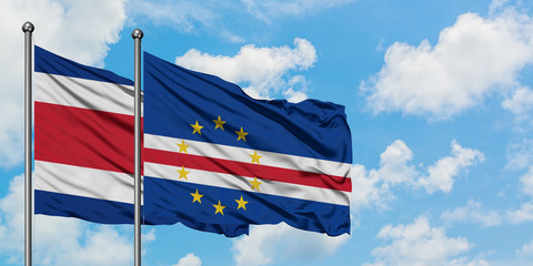 Costa Rica and Cape Verde flag waving in the wind against white cloudy blue sky together. Diplomacy concept, international relations.
