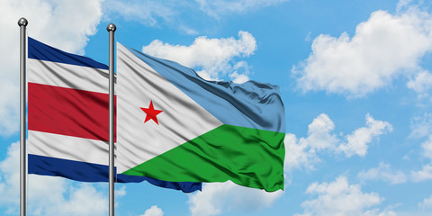 Costa Rica and Djibouti flag waving in the wind against white cloudy blue sky together. Diplomacy concept, international relations.