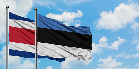 Costa Rica and Estonia flag waving in the wind against white cloudy blue sky together. Diplomacy concept, international relations.