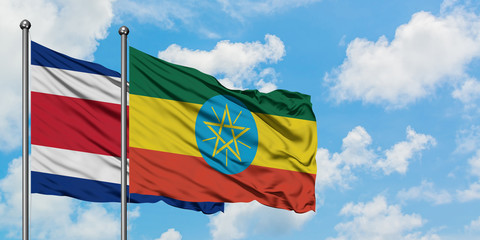Costa Rica and Ethiopia flag waving in the wind against white cloudy blue sky together. Diplomacy concept, international relations.