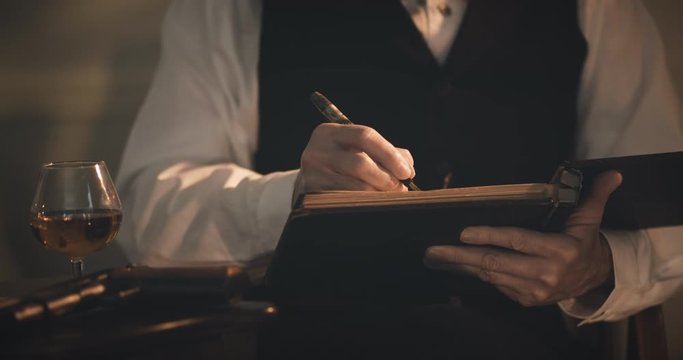 1930s businessman writing in his ledger