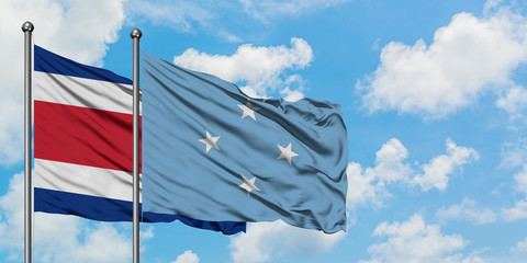 Costa Rica and Micronesia flag waving in the wind against white cloudy blue sky together. Diplomacy concept, international relations.