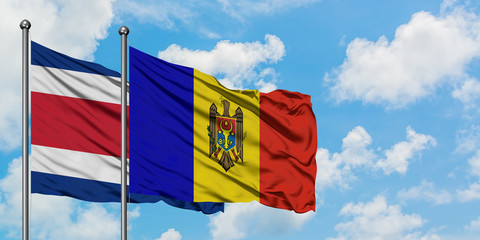 Costa Rica and Moldova flag waving in the wind against white cloudy blue sky together. Diplomacy concept, international relations.
